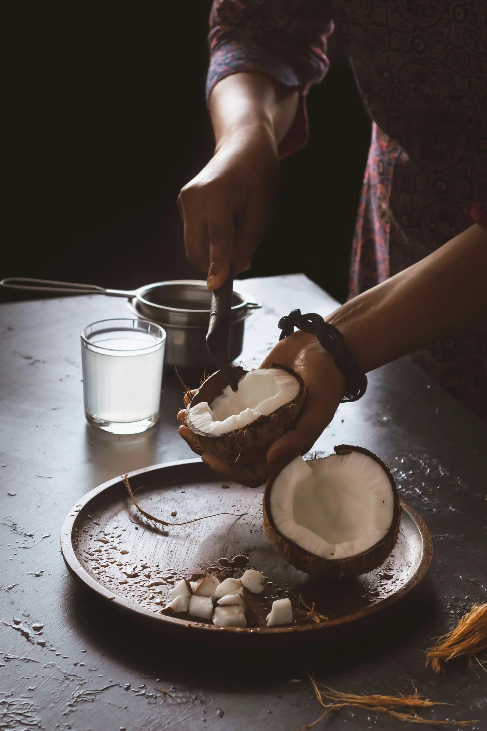 Fresh coconut being opened by hand