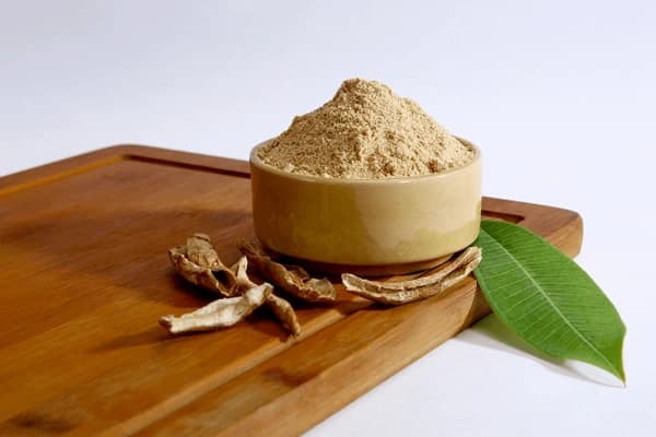 Bowl of food ingredient powder on a wooden board